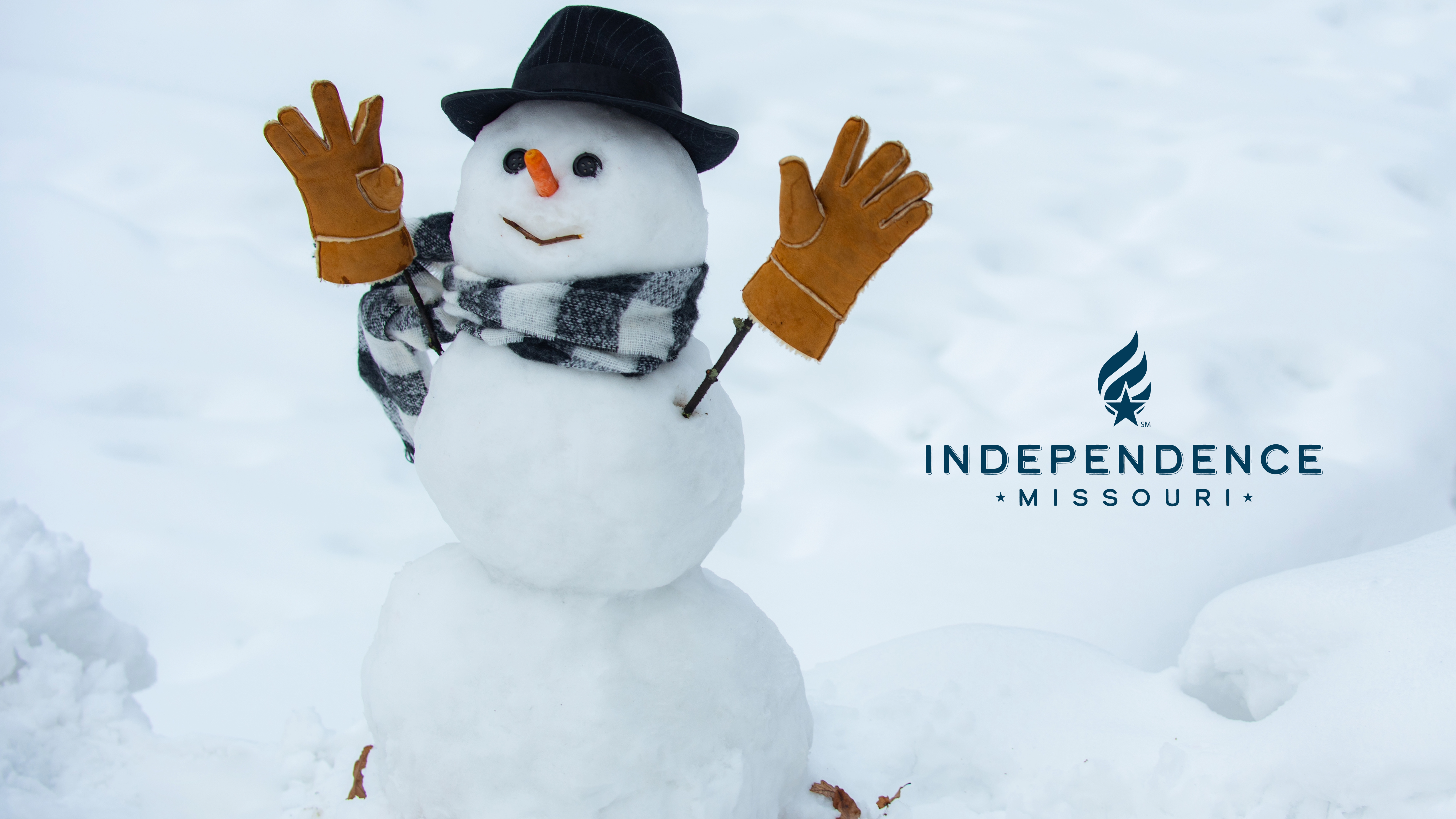 Image of a snowman with a hat, gloves, and scarf with the Independence logo on the right.