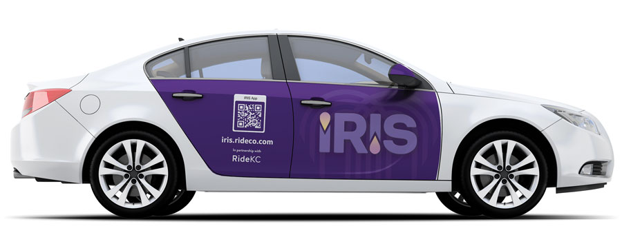 White sedan with a large purple logo over its side doors reading "IRIS"