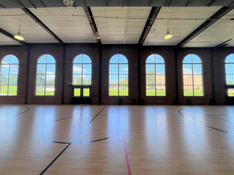 An image of large windows on the West side of the gymnasium inside the Sermon Center.