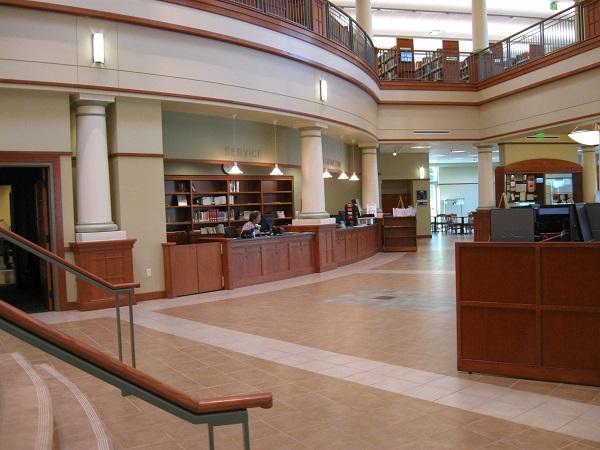 Inside image of the Midwest Genealogy Library. Shows desk and stairs.