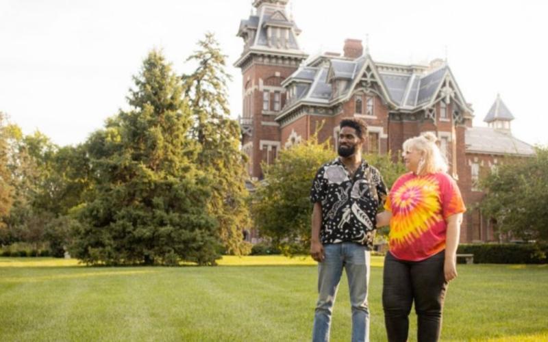 Couple stand outside the Vaile Mansion. 