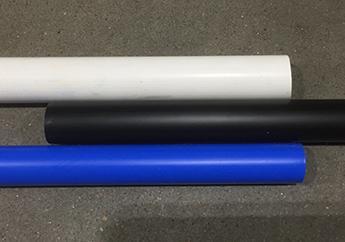 Three plastic pipes, one white, blue, and black