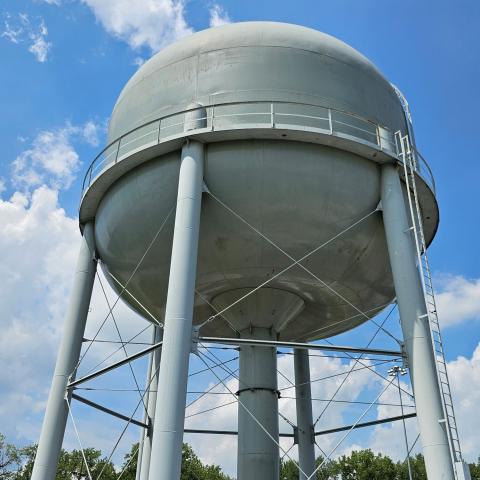 water tower with clouds